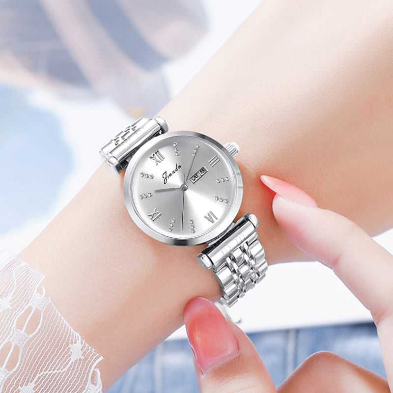 Silver women's quartz watch with stainless steel strap and minimalist round dial.