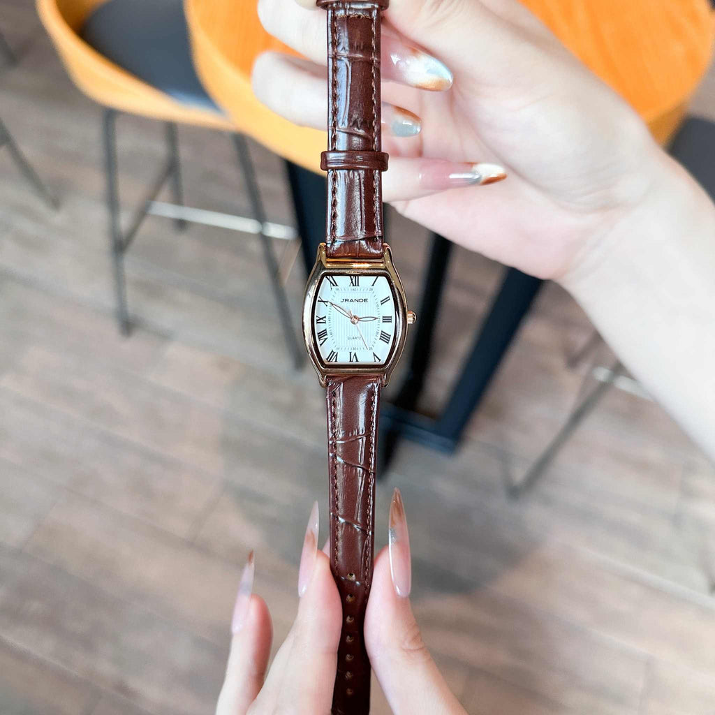 Women's quartz watch with rectangular white dial and brown leather strap, water resistant design.