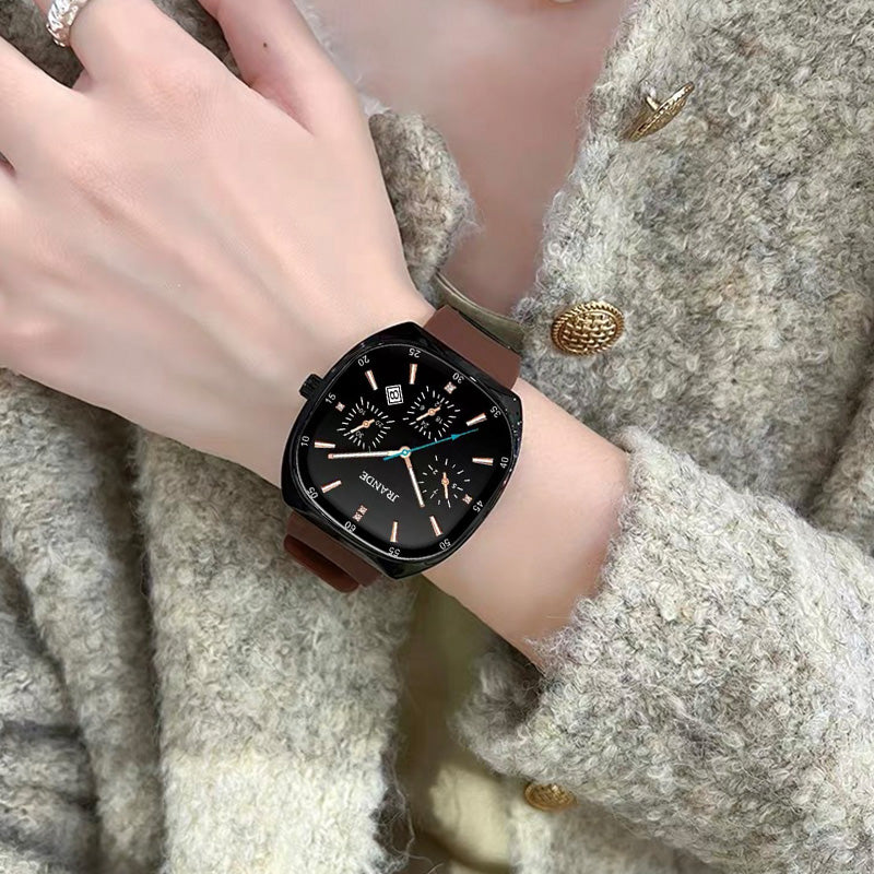 Black JRANDE H9350L quartz watch with brown silicone strap and luminous hands on wrist.