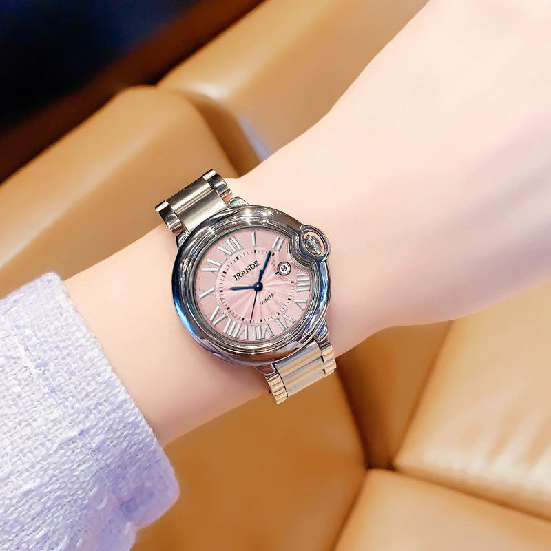 Women's stainless steel quartz watch with round dial and linked metal band on wrist.