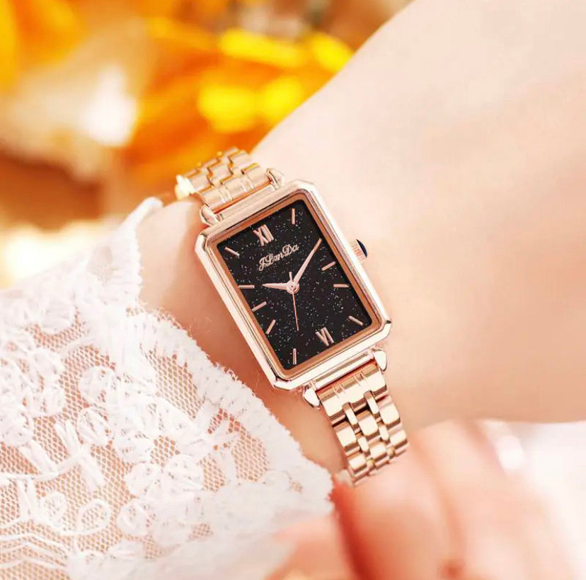 JRANDE J8201L Women's Quartz Watch | Ultra-Slim Stainless Steel | Water Resistant with a rectangular black starry dial and rose gold metal link band on a wrist.