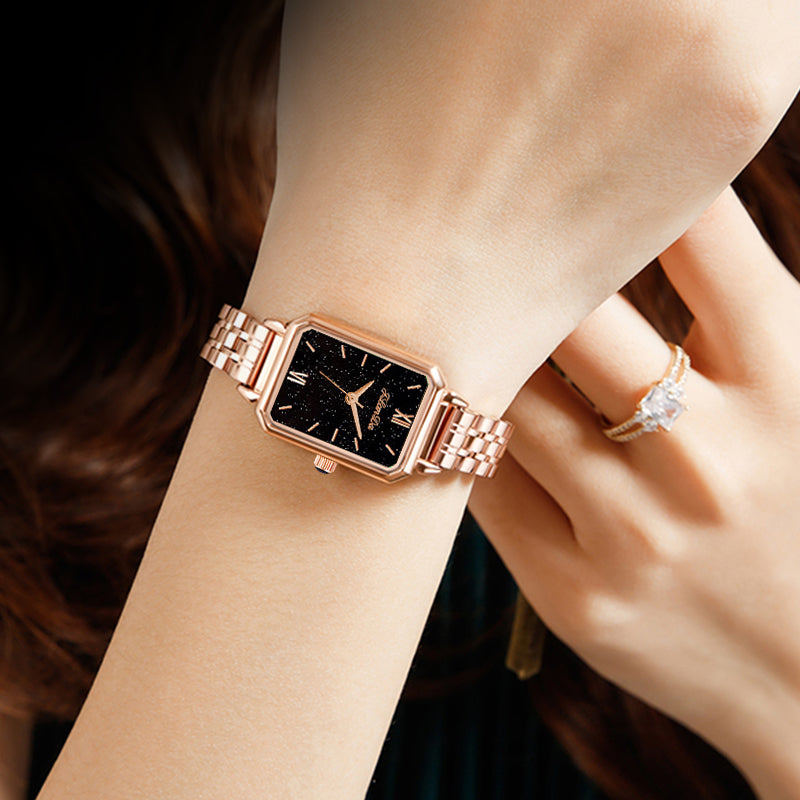 JRANDE J8201L Women's Quartz Watch | Ultra-Slim Stainless Steel | Water Resistant rose gold watch with a rectangular black starry dial on a wrist, showcasing elegance and style.