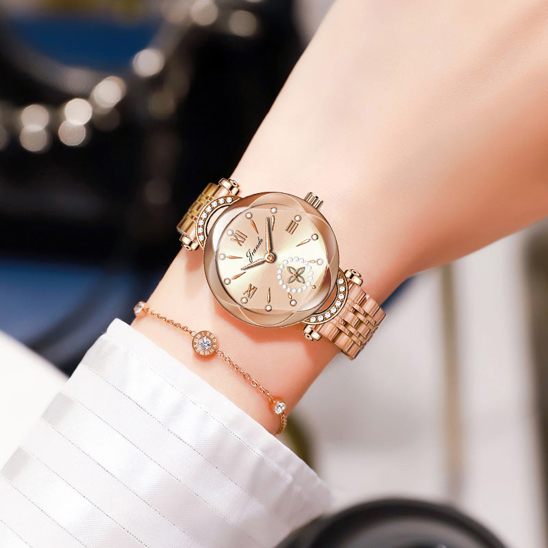 Gold stainless steel women's quartz watch with round dial and link bracelet.