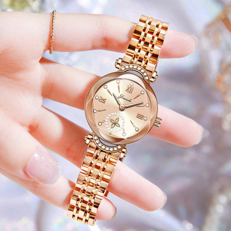Gold stainless steel women's watch with crystal accents and a round dial.