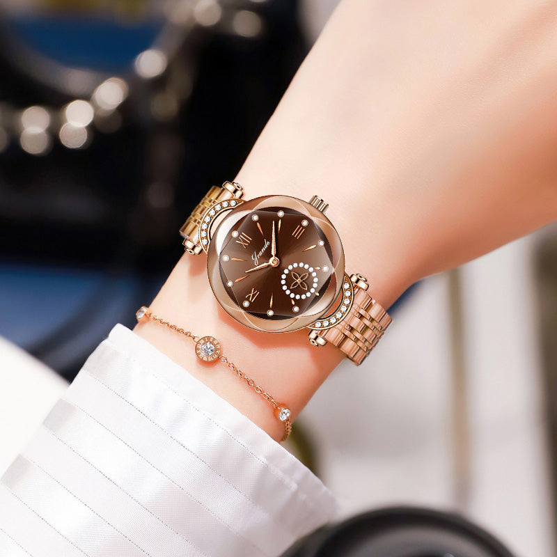 Gold-toned stainless steel women's watch with brown dial and crystal hour markers.