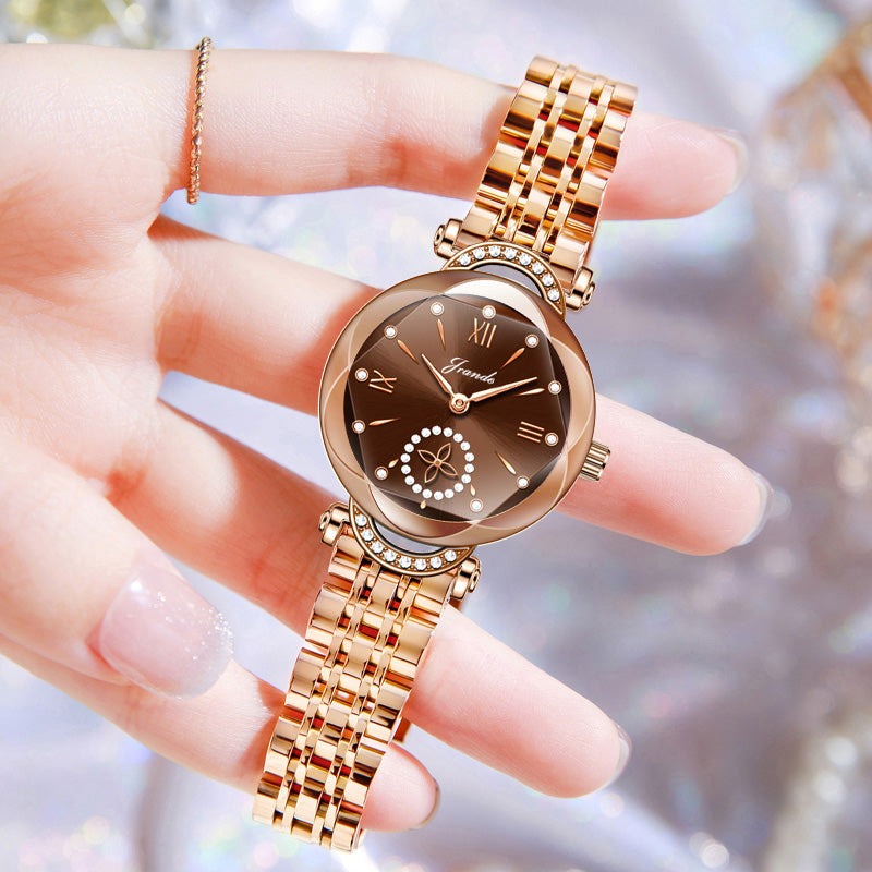 Gold stainless steel women's quartz watch with bronze dial and small seconds subdial.